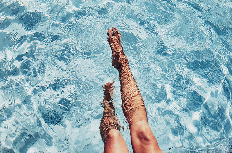Woman's legs in swimming pool